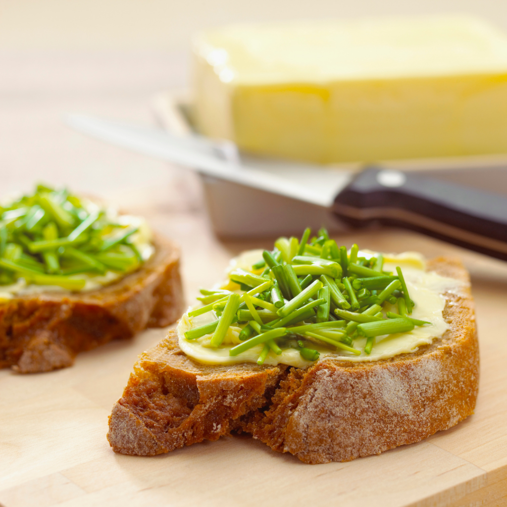 cut chives on bread and butter